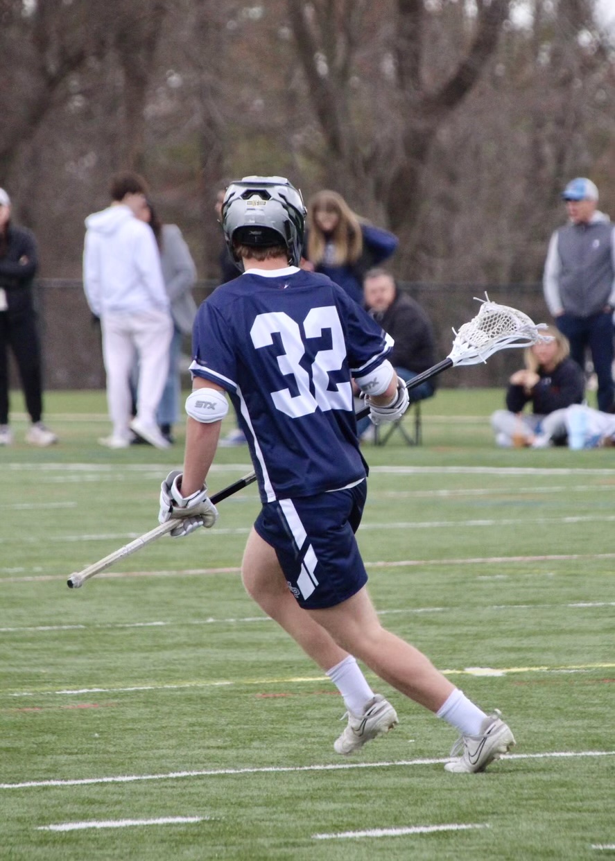 KT playing lacrosse, number 32